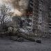 A Ukrainian police officer takes cover in front of a burning building in Avdiivka, Ukraine, Friday, March 17, 2023. The second year of Ukraine’s fight against Russia’s full-scale invasion brought no respite for Ukrainian soldiers or civilians. Associated Press photographers documented the past 12 months of death and destruction, agony and grief — as well as the glimpses of joy — that are staples of life during war. (AP Photo/Evgeniy Maloletka)