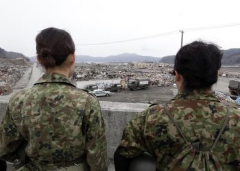 epa02681644 Japanese women soldiers pray for victims in the tsunami- and earthquake-devastated coastal town of Otsuchi, Iwate Prefecture, northeastern Japan on 11 April 2011, a month after the March 11 disaster. The official death toll from the March 11 disaster stood at 12,915 with 14,921 people listed as missing, Japan's National Police Agency said.  EPA/DENNIS M. SABANGAN