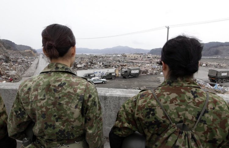 epa02681644 Japanese women soldiers pray for victims in the tsunami- and earthquake-devastated coastal town of Otsuchi, Iwate Prefecture, northeastern Japan on 11 April 2011, a month after the March 11 disaster. The official death toll from the March 11 disaster stood at 12,915 with 14,921 people listed as missing, Japan's National Police Agency said.  EPA/DENNIS M. SABANGAN