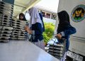 Students collect trays of food supplied by the Indonesian government's free meal programme at an elementary school in Banda Aceh on October 30, 2025. (Photo by CHAIDEER MAHYUDDIN / AFP)