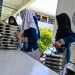 Students collect trays of food supplied by the Indonesian government's free meal programme at an elementary school in Banda Aceh on October 30, 2025. (Photo by CHAIDEER MAHYUDDIN / AFP)