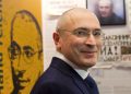 Freed Russian former oil tycoon Mikhail Khodorkovsky smiles as he visits an exhibition in the Museum Haus am Checkpoint Charlie in Berlin, December 22, 2013. Khodorkovsky, pardoned by Russian President Vladimir Putin after 10 years in jail, said in remarks published on Sunday that he would not go into politics or seek to regain assets of his former oil company, Yukos.  REUTERS/Steffi Loos (GERMANY - Tags: POLITICS TPX IMAGES OF THE DAY)