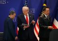 epa12483147 US President Donald Trump (C) looks at a document while standin between Cambodia's Prime Minister Hun Manet (L) and Thailand's Prime Minister Anutin Charnvirakul (R) on the sidelines of the 47th Association of Southeast Asian Nations (ASEAN) Summit in Kuala Lumpur, Malaysia, 26 October 2025.  EPA/MOHD RASFAN / POOL