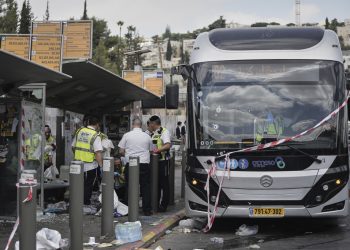 Israeli police and rescue teams inspect the scene of a shooting attack carried out by two Palestinian gunmen, in which several people were killed and others injured at a bus stop in Jerusalem, Monday, Sept. 8, 2025. (AP Photo/Mahmoud Illean)
