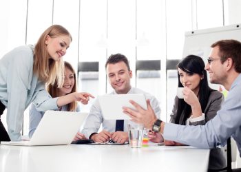 Group of business people working with digital tablet in office