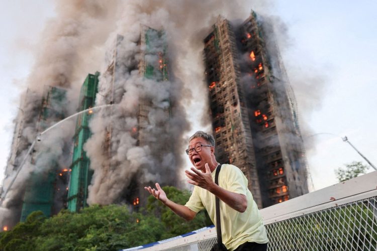 Wong 71, reacts after claiming his wife is trapped inside Wang Fuk Court during a major fire, in Tai Po, Hong Kong, China, November 26, 2025. REUTERS/Tyrone Siu   TPX IMAGES OF THE DAY