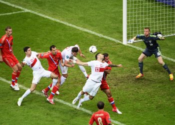epa03262030 Marcin Wasilewski (no.13) of Poland jumps for a header during the Group A preliminary round match of the UEFA EURO 2012 between Poland and Russia in Warsaw, Poland, 12 June 2012. EPA/BARTLOMIEJ ZBOROWSKI UEFA Terms and Conditions apply http://www.epa.eu/downloads/UEFA-EURO2012-TCS.pdf