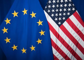 The national flag of the United States next to the European flag