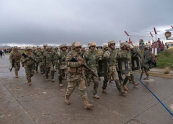 A military patrol marches at the scene of the crash in El Alto on Feb. 28.