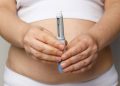 Woman showing opened Semaglutide Injection pen or insulin cartridge pen. Weight loss and diabetes concept.