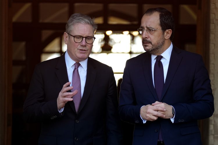 Cyprus' President Nikos Christodoulides, right, and Britain's Prime Minister Keir Starmer talk outside the presidential palace after their meeting, in capital Nicosia, Cyprus, Tuesday, Dec. 10, 2024. (AP Photo/Petros Karadjias)